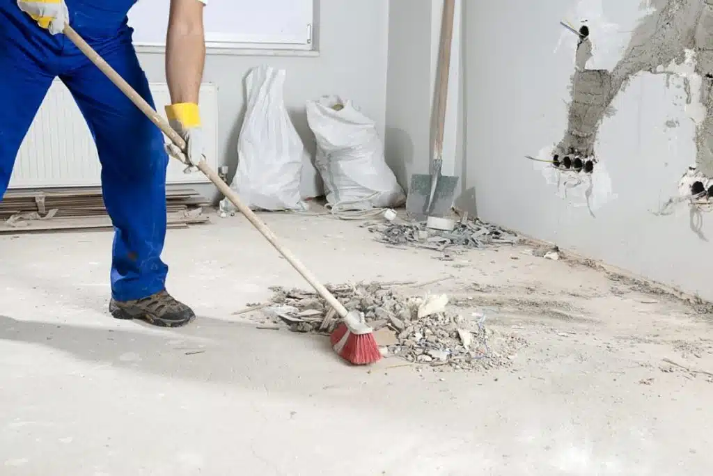 Post Construction Cleaning photo of person cleaning up debris