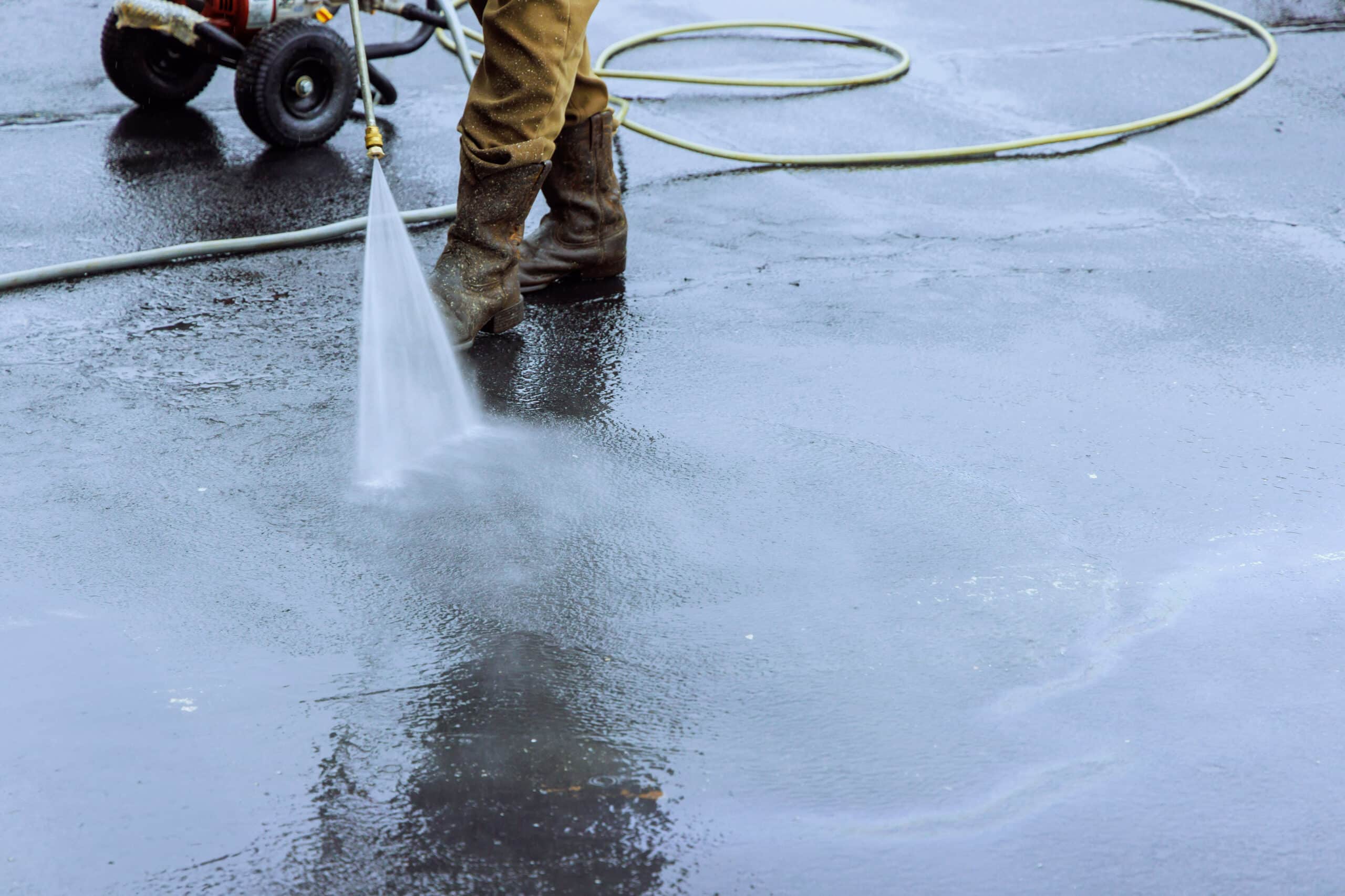 Man power washing a commerical concrete space